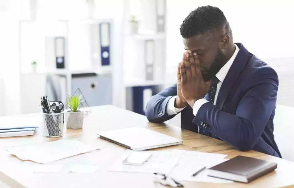 Young tired businessman having stress at work