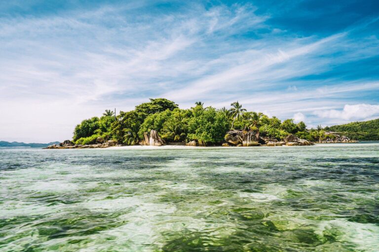small island in shallow island at port glaud lagoon mahe island seychelles